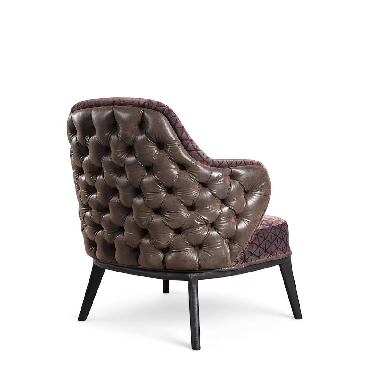 Rear angled view of the Vaya Home Array accent chair with a button-tufted brown leather back, patterned seat and inner back, and black legs.