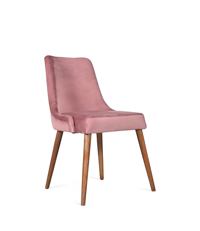Front angled view of the Vaya Home Arrossire dining chair with pink velvet upholstery, cushioned seat, and tapered wood legs.