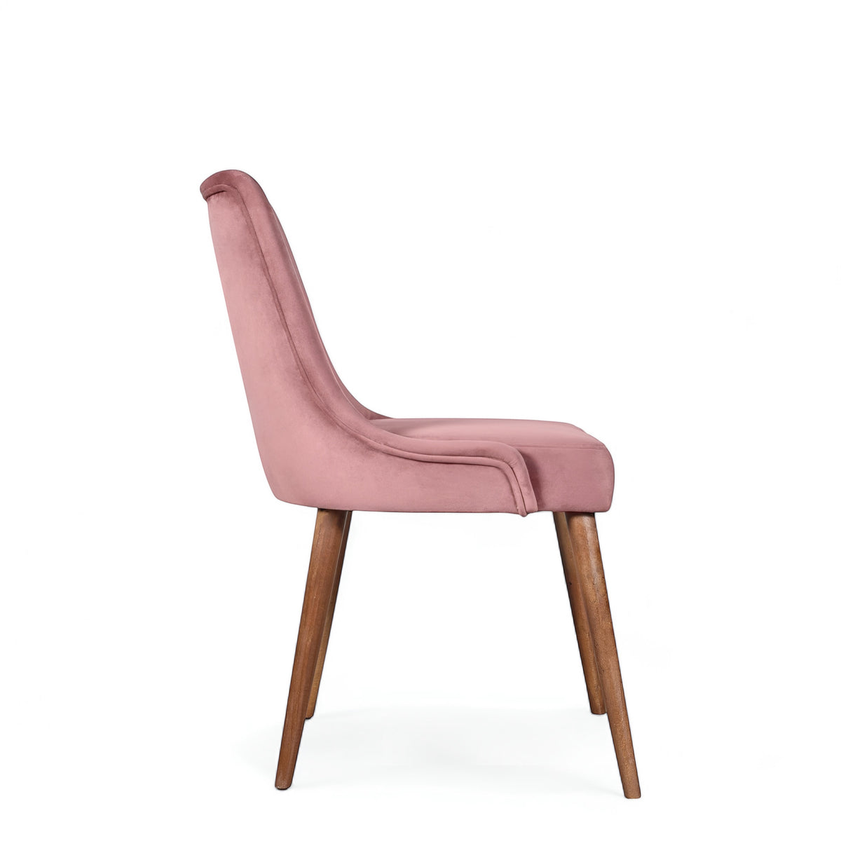 Side view of the Vaya Home Arrossire dining chair with pink velvet upholstery, slim profile, and tapered wood legs.