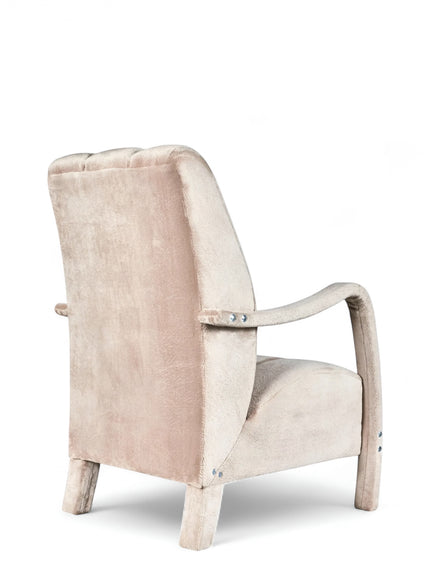 Rear angled view of the Vaya Home Aura accent chair with beige upholstery, curved wood arms, and a tall upholstered back.