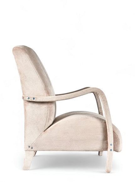 Side view of the Vaya Home Aura accent chair featuring beige upholstery, curved wood arms, and a tall channel-tufted backrest.