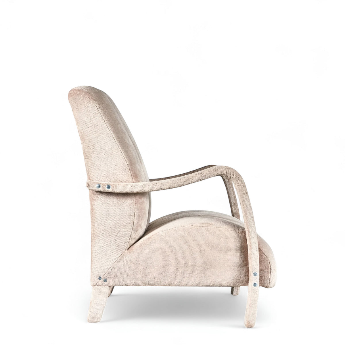 Side view of the Vaya Home Aura accent chair featuring beige upholstery, curved wood arms, and a tall channel-tufted backrest.