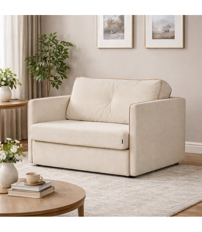 Vaya Home Aureo chair bed in cream boucle upholstery, styled in a modern living room.