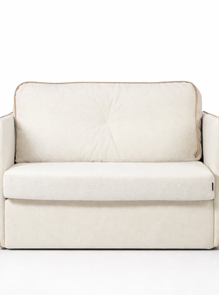 Front view of the Vaya Home Aureo sleeper chair with cream boucle upholstery, wide arms, and piped edge detailing.