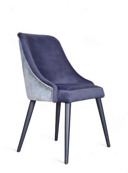 Front angled view of the Vaya Home Azzurro dining chair with dark blue upholstery, slim profile, and tapered dark legs.