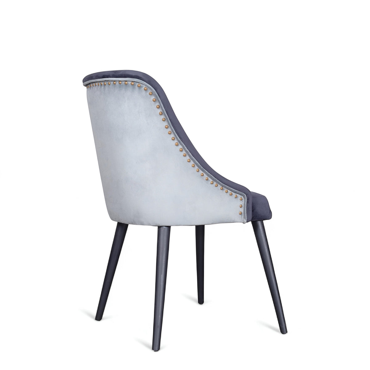 Side view of the Vaya Home Azzurro dining chair with dark blue upholstery, contrast piping, and tapered dark legs.