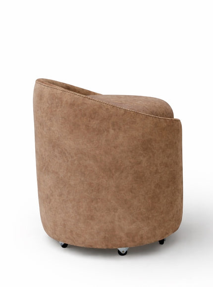 Back view of the Vaya Home Barrel round storage ottoman with curved brown upholstered sides.