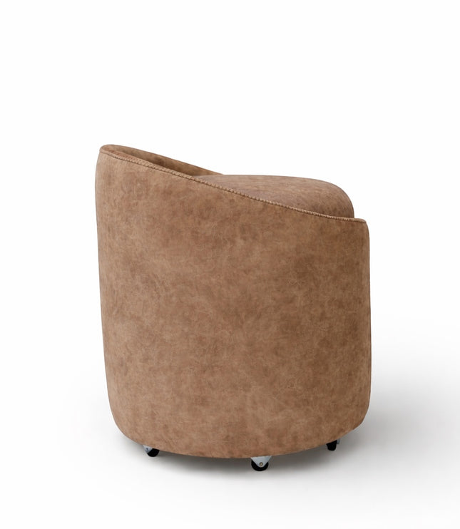 Back view of the Vaya Home Barrel round storage ottoman with curved brown upholstered sides.