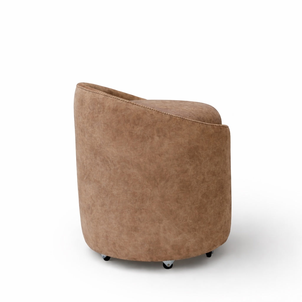 Back view of the Vaya Home Barrel round storage ottoman with curved brown upholstered sides.