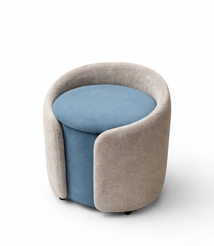 Vaya Home Barrel round storage ottoman with blue seat cushion and cream upholstered exterior.