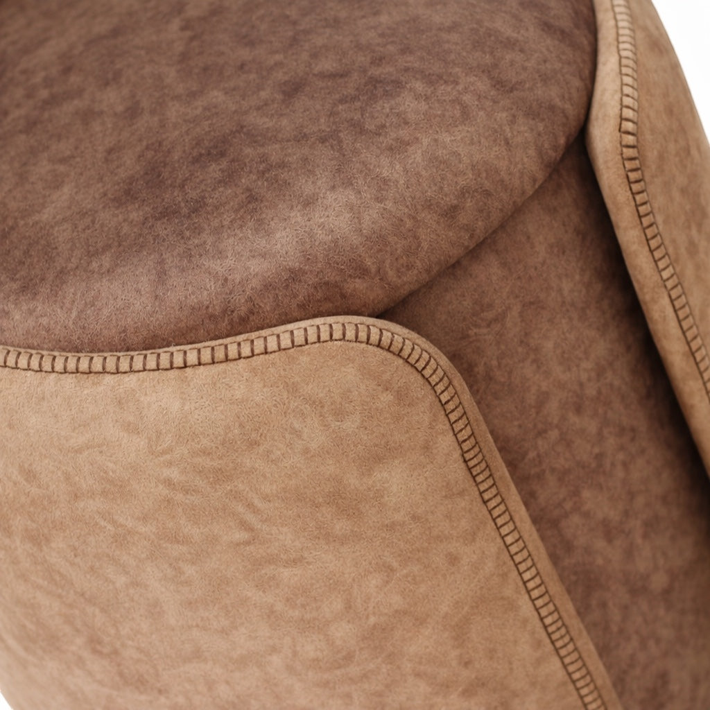 Close-up of the Vaya Home Barrel storage ottoman showing brown upholstered texture and stitched edge detailing.