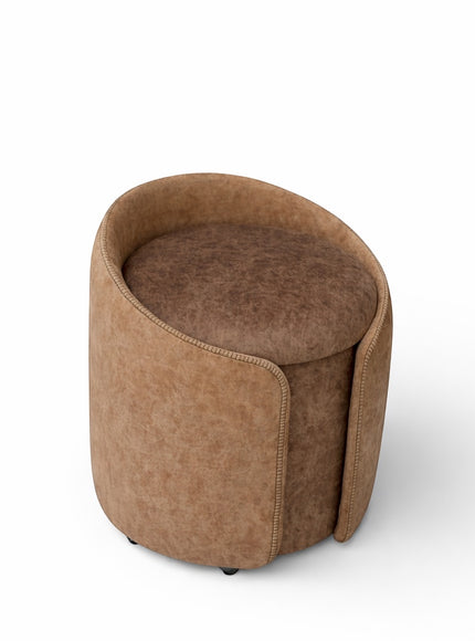 Front view of the Vaya Home Barrel round storage ottoman with two-tone brown upholstery and cushioned top.