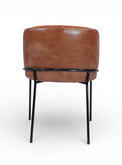 Back view of the Vaya Home Batata dining chair featuring brown upholstery and slim black metal legs.