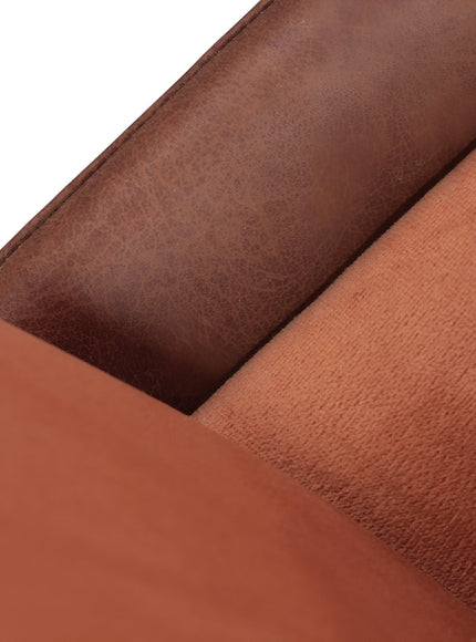 Close-up of the Vaya Home Batata dining chair showing brown upholstery and stitched seam detail.