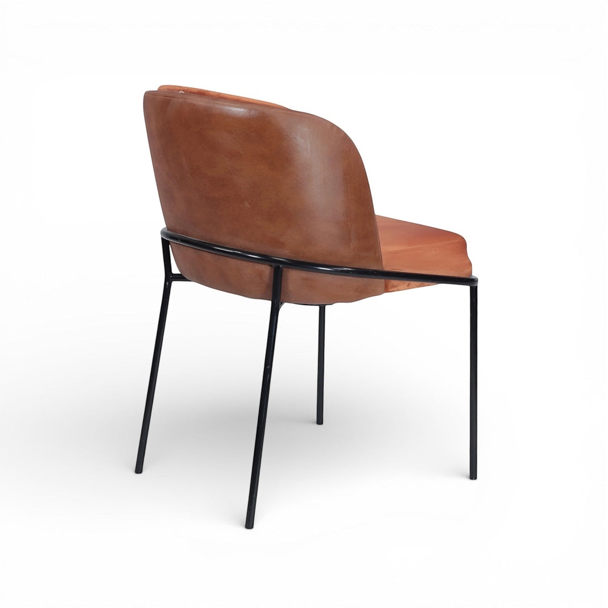 Rear angled view of the Vaya Home Batata dining chair with brown upholstery and slim black metal legs.