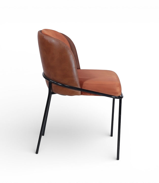 Side view of the Vaya Home Batata dining chair featuring brown upholstery, a curved backrest, and slim black metal legs.