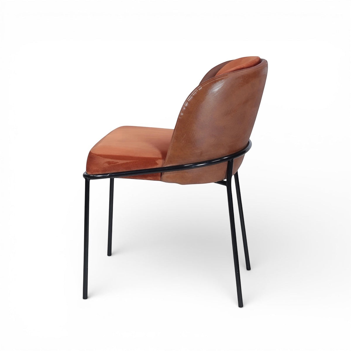 Opposite side view of the Vaya Home Batata dining chair with brown upholstery, curved backrest, and slim black metal legs.
