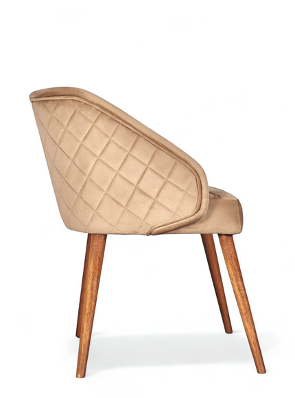 Side view of the Vaya Home Biscotta dining chair with beige upholstery, quilted outer back, and tapered wood legs.