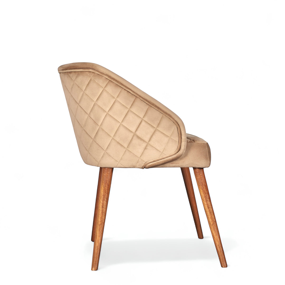 Side view of the Vaya Home Biscotta dining chair with beige upholstery, quilted outer back, and tapered wood legs.