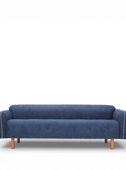 Vaya Home Blaire sofa in blue upholstery, styled in a modern living room with the Beige Cloud accent chair.