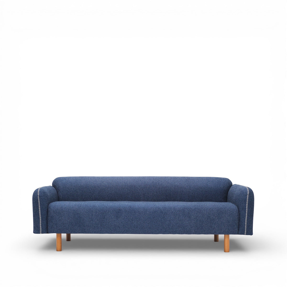 Vaya Home Blaire sofa in blue upholstery, styled in a modern living room with the Beige Cloud accent chair.