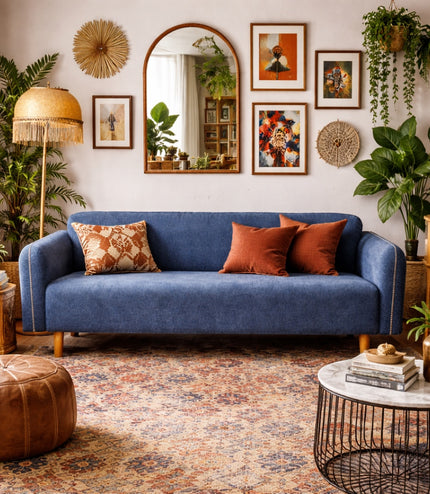 Vaya Home Blaire sofa in blue upholstery, styled in a warm eclectic living room with accent cushions.