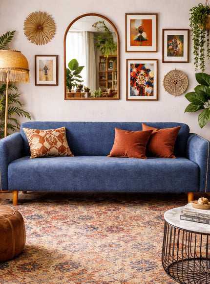 Vaya Home Blaire sofa in blue upholstery, styled in a warm eclectic living room with accent cushions.