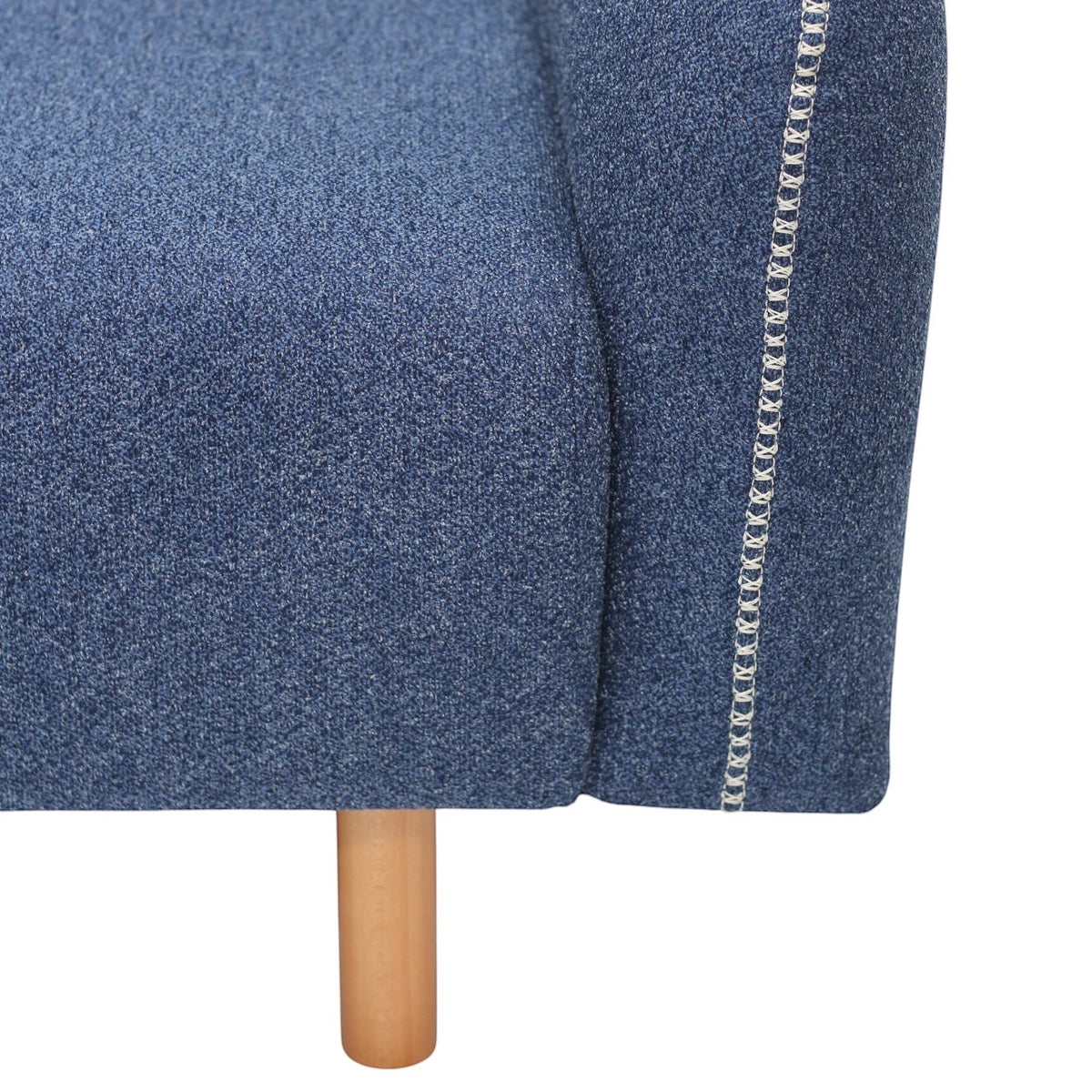 Close-up of the Vaya Home Blaire sofa showing blue upholstery, contrast stitching, and wood leg detail.