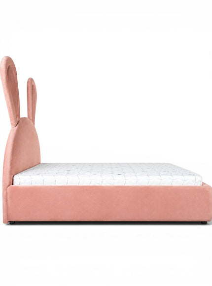 Side view of the Vaya Home Bunny kids bed with pink upholstery, a low platform frame, and a bunny ear headboard.