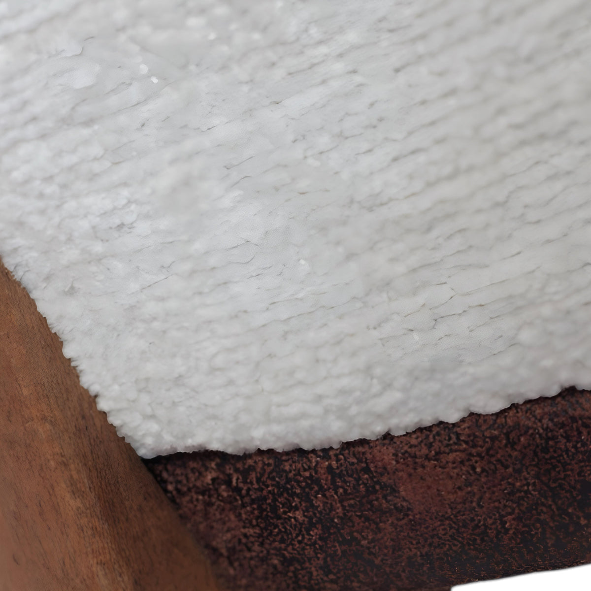 Close-up of the Vaya Home Cadena dining chair showing white boucle upholstery and wood frame detail.