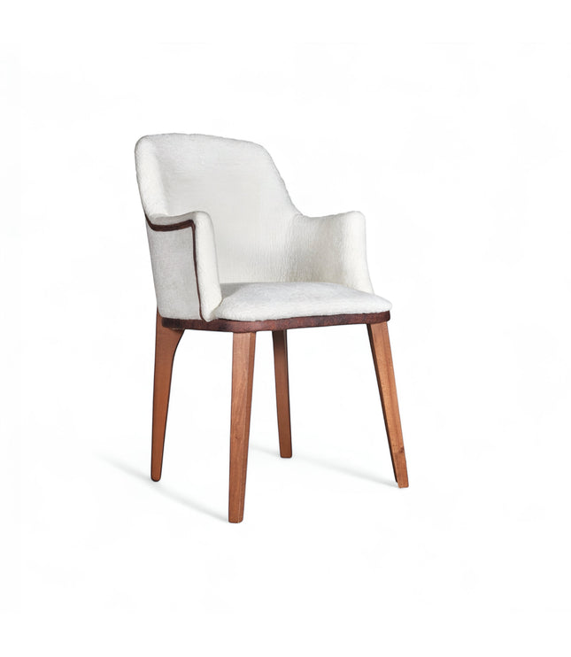 Front angled view of the Vaya Home Cadena dining chair with white boucle upholstery, sculpted arms, and tapered wood legs.