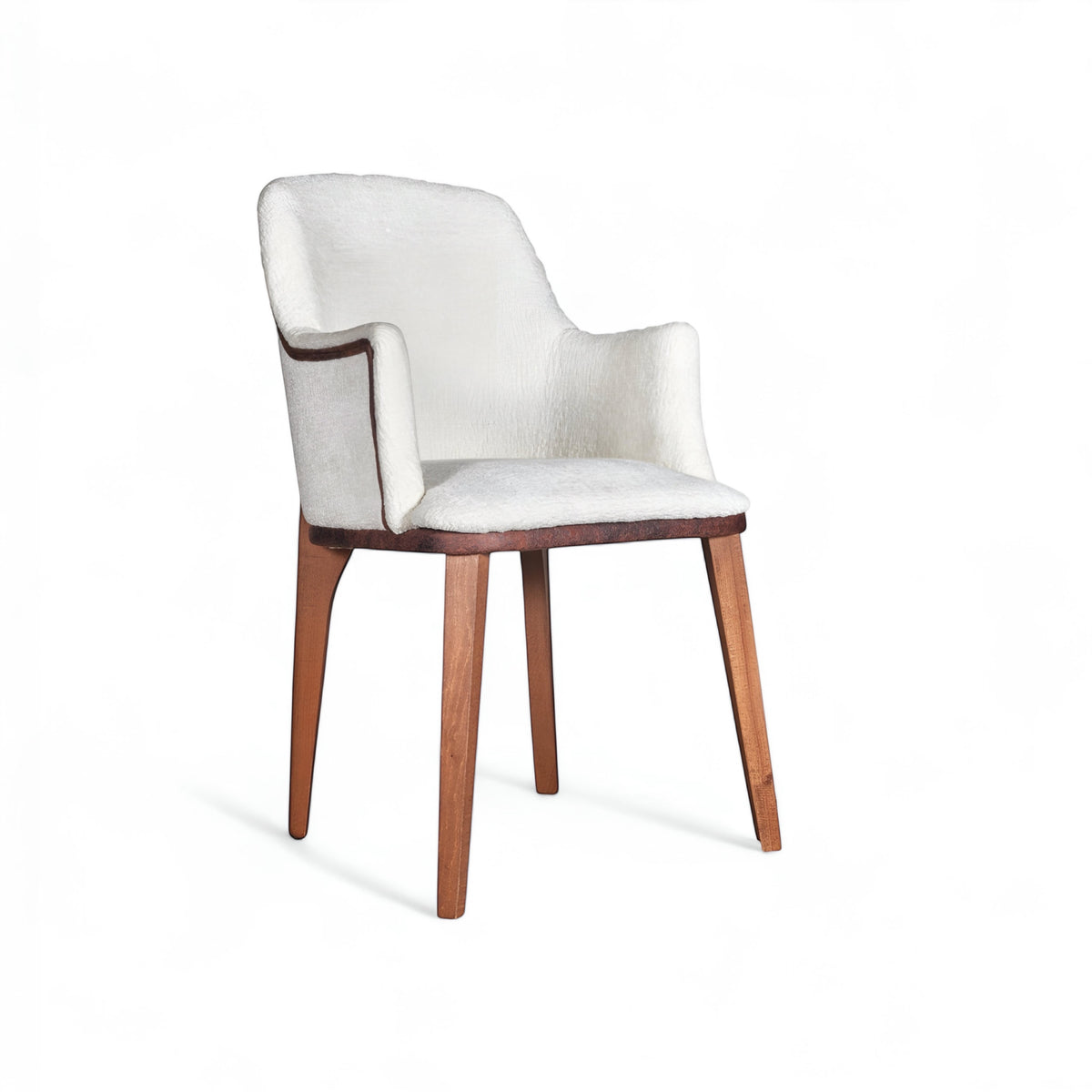 Front angled view of the Vaya Home Cadena dining chair with white boucle upholstery, sculpted arms, and tapered wood legs.