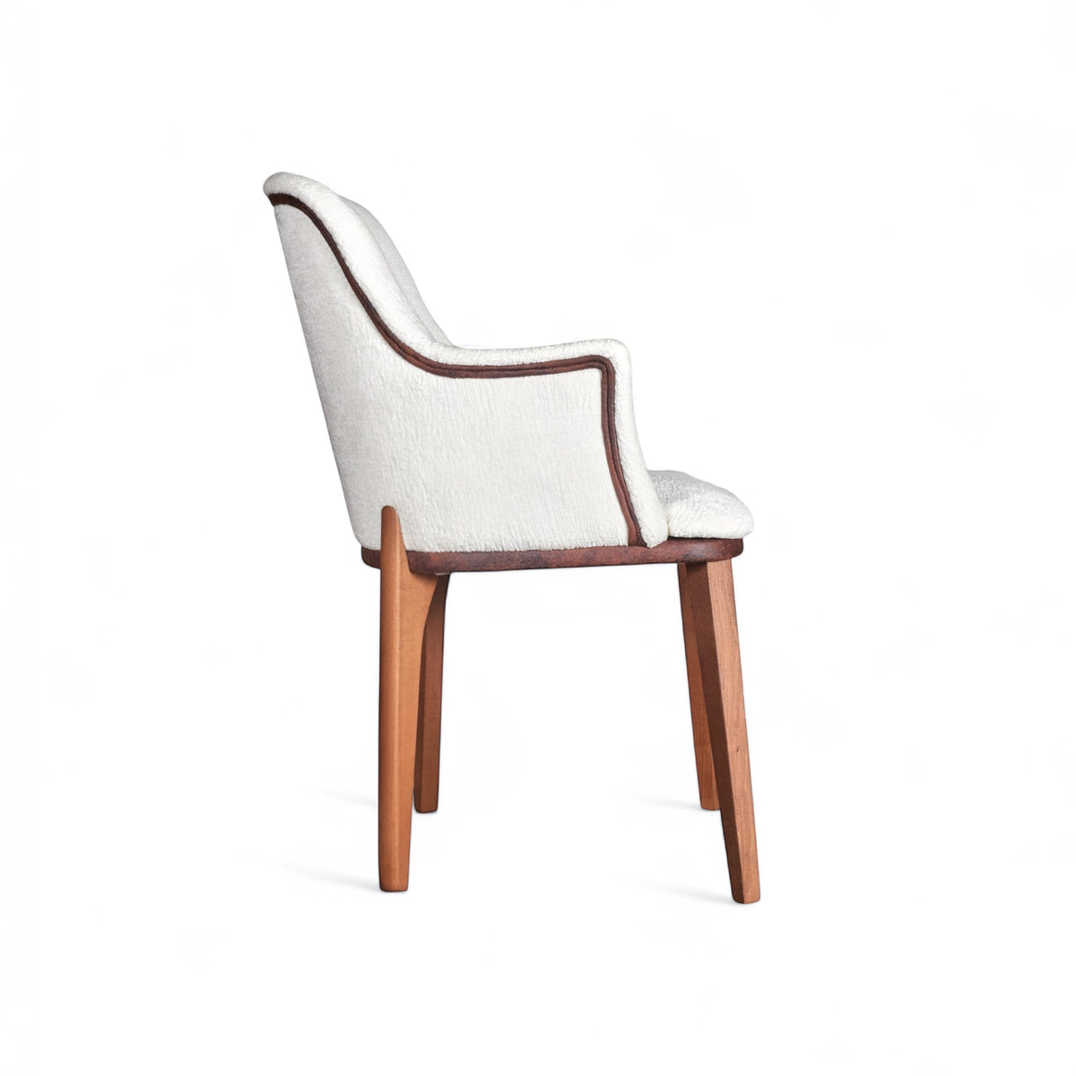 Side view of the Vaya Home Cadena dining chair with white boucle upholstery, curved arm detail, and tapered wood legs.