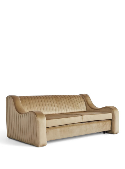 Angled view of the Vaya Home Cappuccino sofa bed featuring beige upholstery, rolled arms, and a channel-tufted backrest.