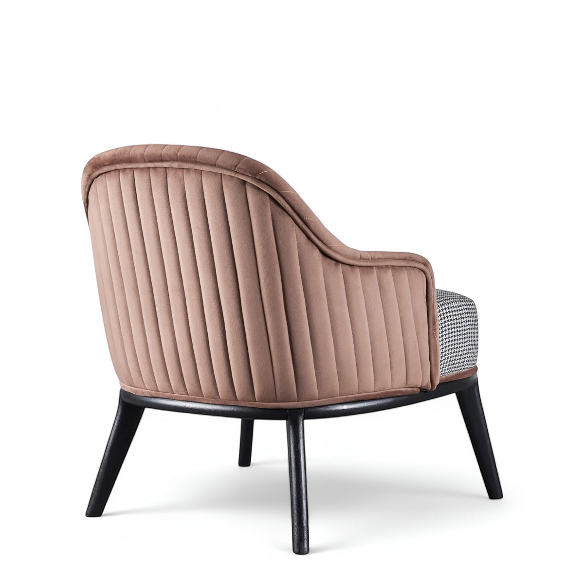 Rear angled view of the Vaya Home Carruba accent chair with a rose gold channel-tufted back, gray seat cushion, and black legs.