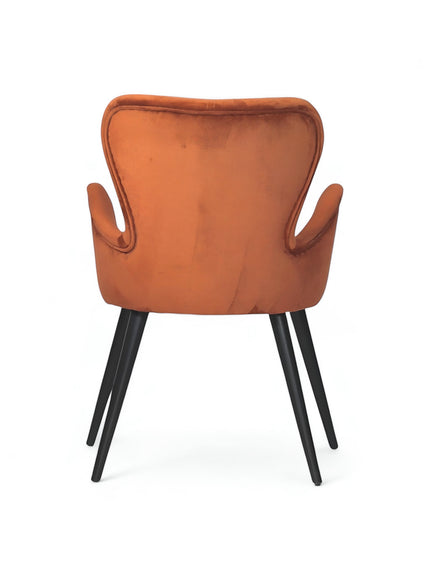 Back view of the Vaya Home Celebrity accent chair featuring orange upholstery, a curved backrest, and black tapered legs.