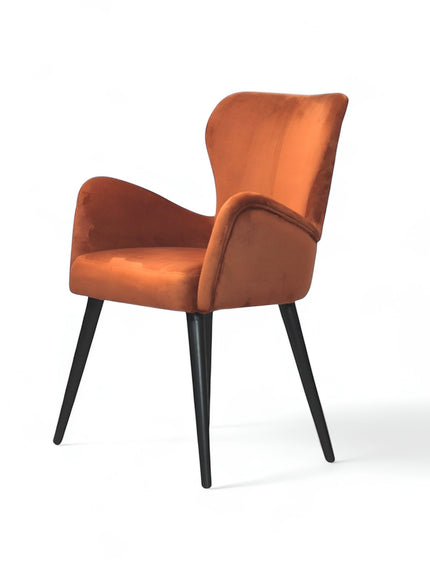 Front angled view of the Vaya Home Celebrity accent chair with orange upholstery, sculpted arms, and black tapered legs.