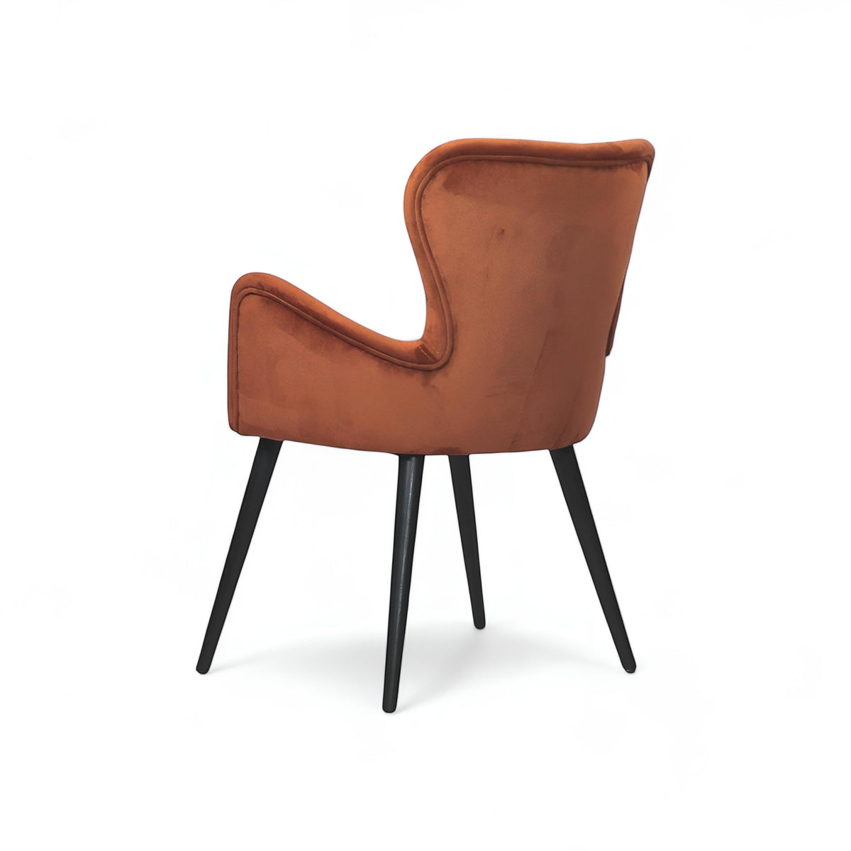 Rear angled view of the Vaya Home Celebrity accent chair with orange upholstery, sculpted arms, and black tapered legs.