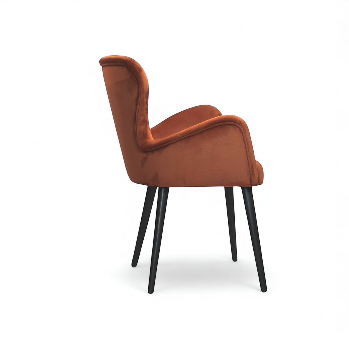 Side view of the Vaya Home Celebrity accent chair with orange upholstery, sculpted arms, and black tapered legs.