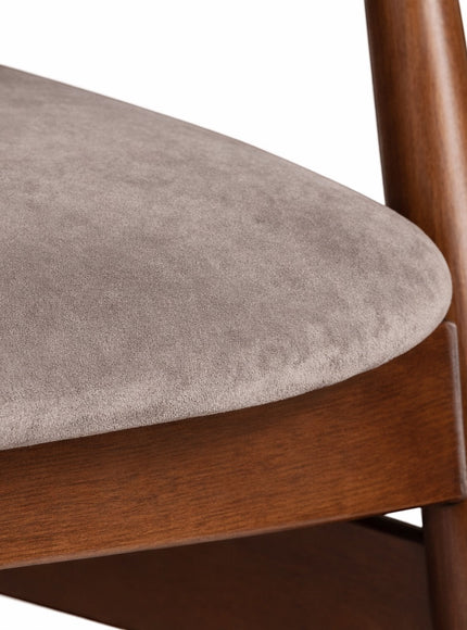 Close-up of the Vaya Home Chairo dining chair showing taupe upholstery and wood frame detail.