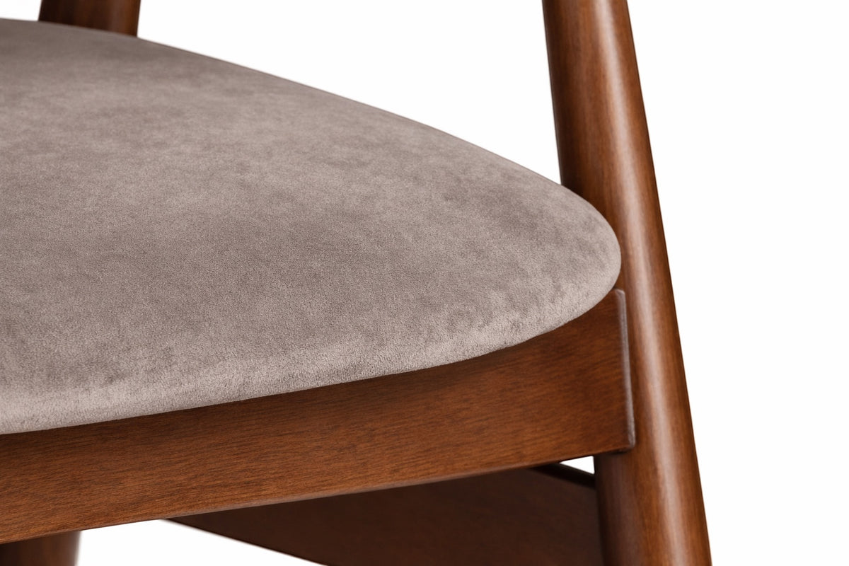Close-up of the Vaya Home Chairo dining chair showing taupe upholstery and wood frame detail.
