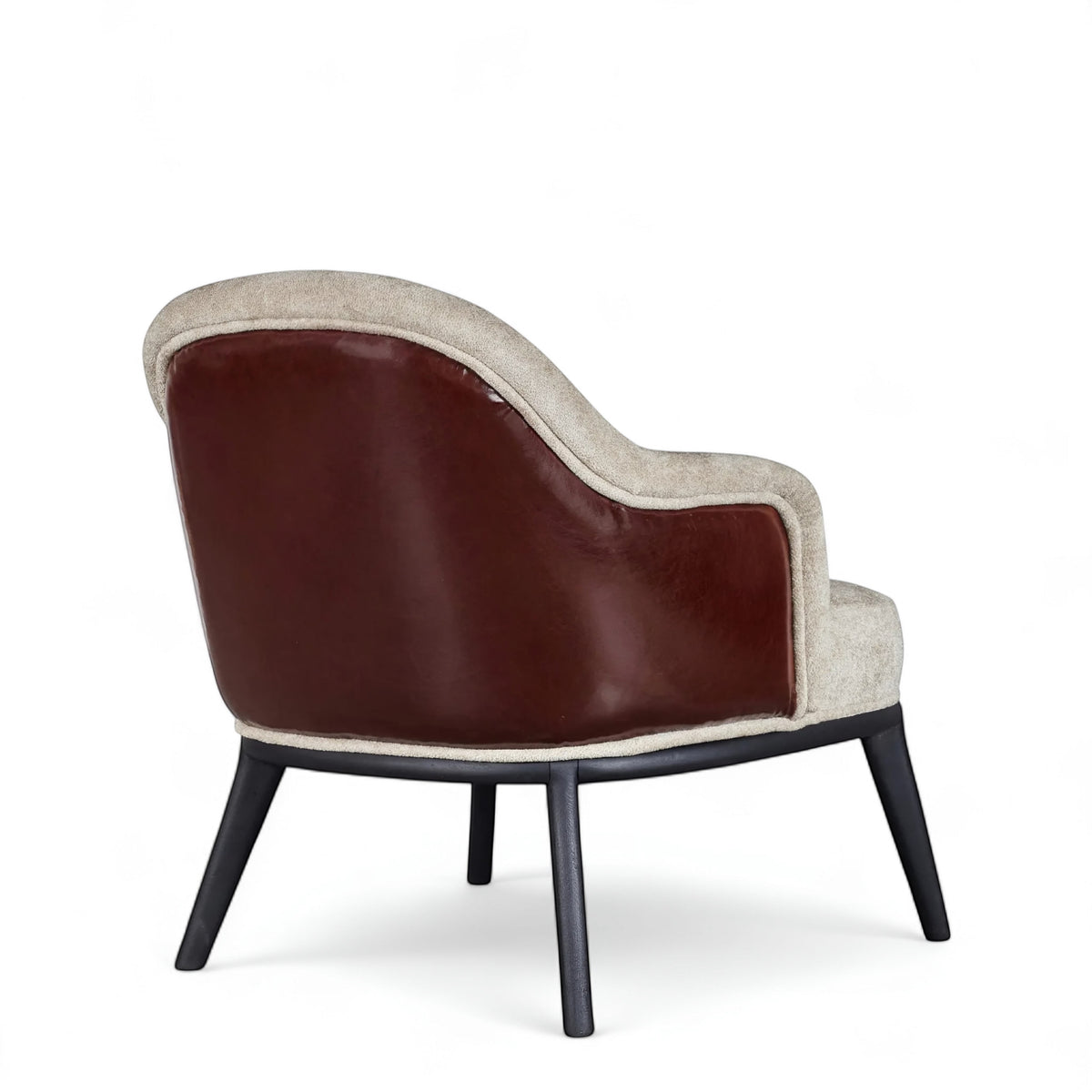 Rear angled view of the Vaya Home Chocolate accent chair with a brown leather outer back, beige upholstered seat, and black legs.