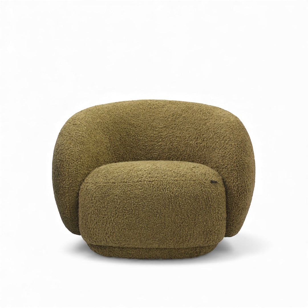 Angled view of the Vaya Home Cloud 2.0 accent chair featuring a rounded sculptural shape and olive green boucle upholstery.
