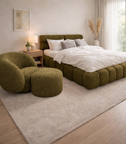 Vaya Home Cloud 2.0 chair with matching ottoman and Forma bed in olive green upholstery, styled in a modern bedroom.
