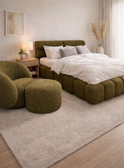 Vaya Home Cloud 2.0 chair with matching ottoman and Forma bed in olive green upholstery, styled in a modern bedroom.