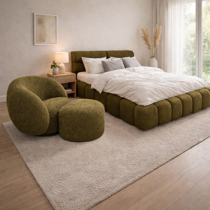Vaya Home Cloud 2.0 chair with matching ottoman and Forma bed in olive green upholstery, styled in a modern bedroom.