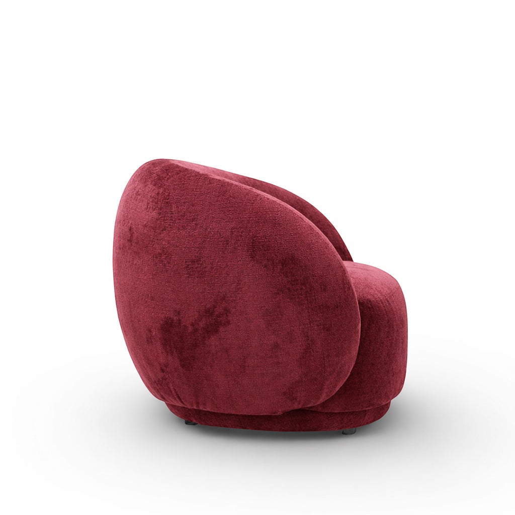 Rear angled view of the Vaya Home Cloud accent chair featuring red upholstery and a rounded sculptural back.