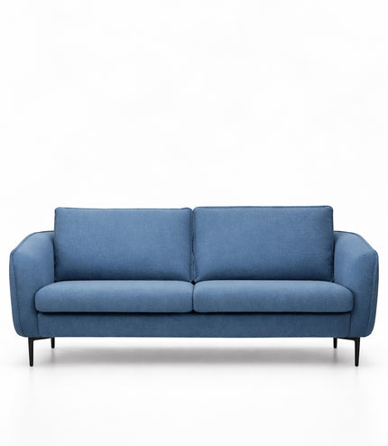 Front view of the Vaya Home Cobalt sofa with blue upholstery, slim arms, two seat cushions, and accent pillows.