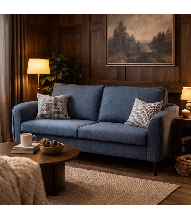 Vaya Home Cobalt sofa in blue upholstery, styled in a warm modern living room with accent pillows.