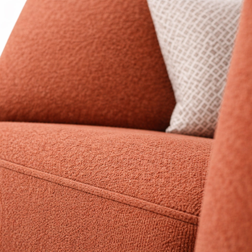 Close-up of the Vaya Home Cobalt sofa showing orange upholstery and textured seat cushion detail.